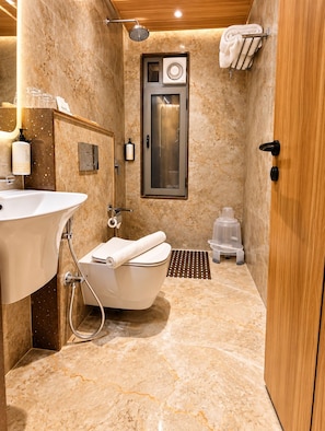 A modern bathroom with a freestanding bathtub, a sink, and a toilet.