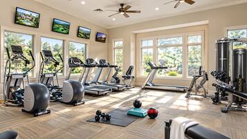 A gym with treadmills, ellipticals, and weight equipment.