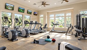 A gym with treadmills, ellipticals, and weight equipment.