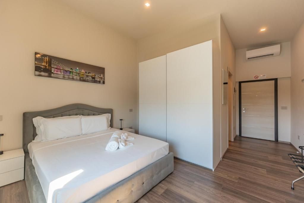 Une chambre à coucher avec un lit, une armoire, un tableau et un appareil de climatisation.
