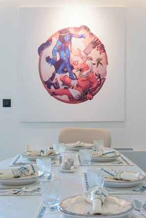A dining table set with plates, glasses, and a napkin. - 3 Bedroom Apartment at Glyfada’s Centre (Glyfada)