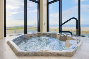 A hot tub with a marble design, large windows, and a view of the beach. - Phoenix Ii 2104 1 Bedroom Condo (Orange Beach)