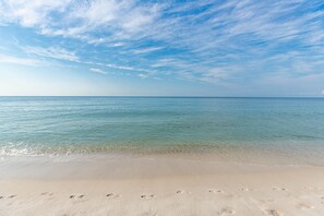 A beach with clear water and a sandy shore. - Phoenix Ii 2074 1 Bedroom Condo (Orange Beach)