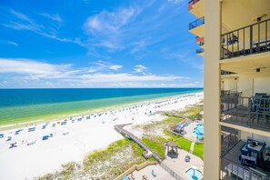 A beach view with a pool and a building with balconies. - Phoenix Ii 2108 3 Bedroom Condo (Orange Beach)