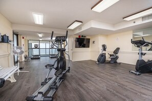 A gym with treadmills, elliptical machines, and a fan. - Phoenix Ii 2063 2 Bedroom Condo (Orange Beach)