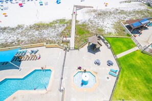 A resort with a swimming pool, a water slide, and a beach area. - Phoenix Ii 2063 2 Bedroom Condo (Orange Beach)