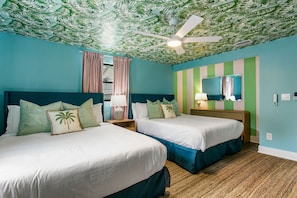 A hotel room with two beds, a ceiling fan, a mirror, and a striped wall. - Luxury Resort - Pool · GolfSim · GameRoom· FirePit· Hot Tub (Seminole)