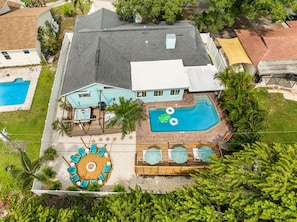 A two-story house with a swimming pool, a hot tub, and a deck with lounge chairs. - Luxury Resort - Pool · GolfSim · GameRoom· FirePit· Hot Tub (Seminole)