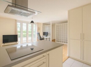A modern kitchen with a large island, built-in appliances, and a view to the outdoors. - Tranquil 1-bedroom apartment in the heart of London right next to the riverside (London)