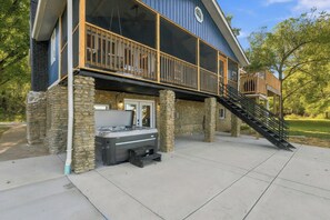 Ein zweigeschossiges Gebäude mit einem Balkon, einer Whirlpool-Badewanne und einer Treppe, die zu einer oberen Ebene führt.