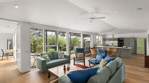 A spacious living area with a sofa set, a dining table, and a kitchen in the background. - Quat Quatta - Point Lonsdale (Point Lonsdale)