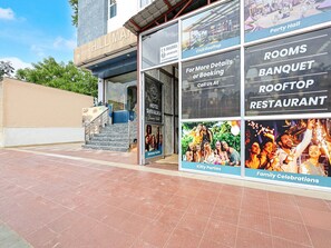 A hotel with a sign for a grocery store, a party hall, and a rooftop restaurant. - Deluxe Room Hotel Shivalika (Jaipur)
