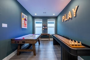 A room with two foosball tables, a billiards table, and a wall-mounted sign. - Family Retreat: Hot Tub, Game Loft, 3 Ensuites (Houston)