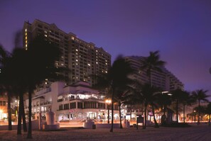 A hotel with multiple floors, a prominent entrance, and palm trees in the foreground. - Marriott's BeachPlace Towers 1 Guest Room,1 King, Sofa Bed, Balcony-Beach Vacay (Fort Lauderdale)