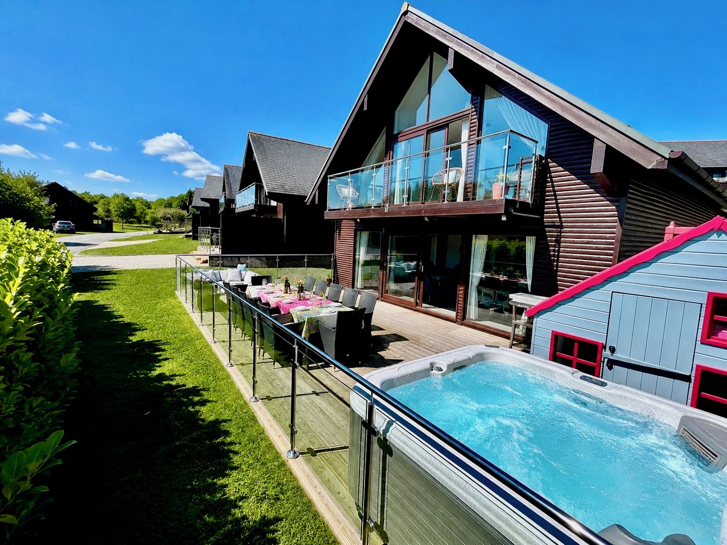 Een modern herenhuis met zwembad, terras en een groot glazen balkon.