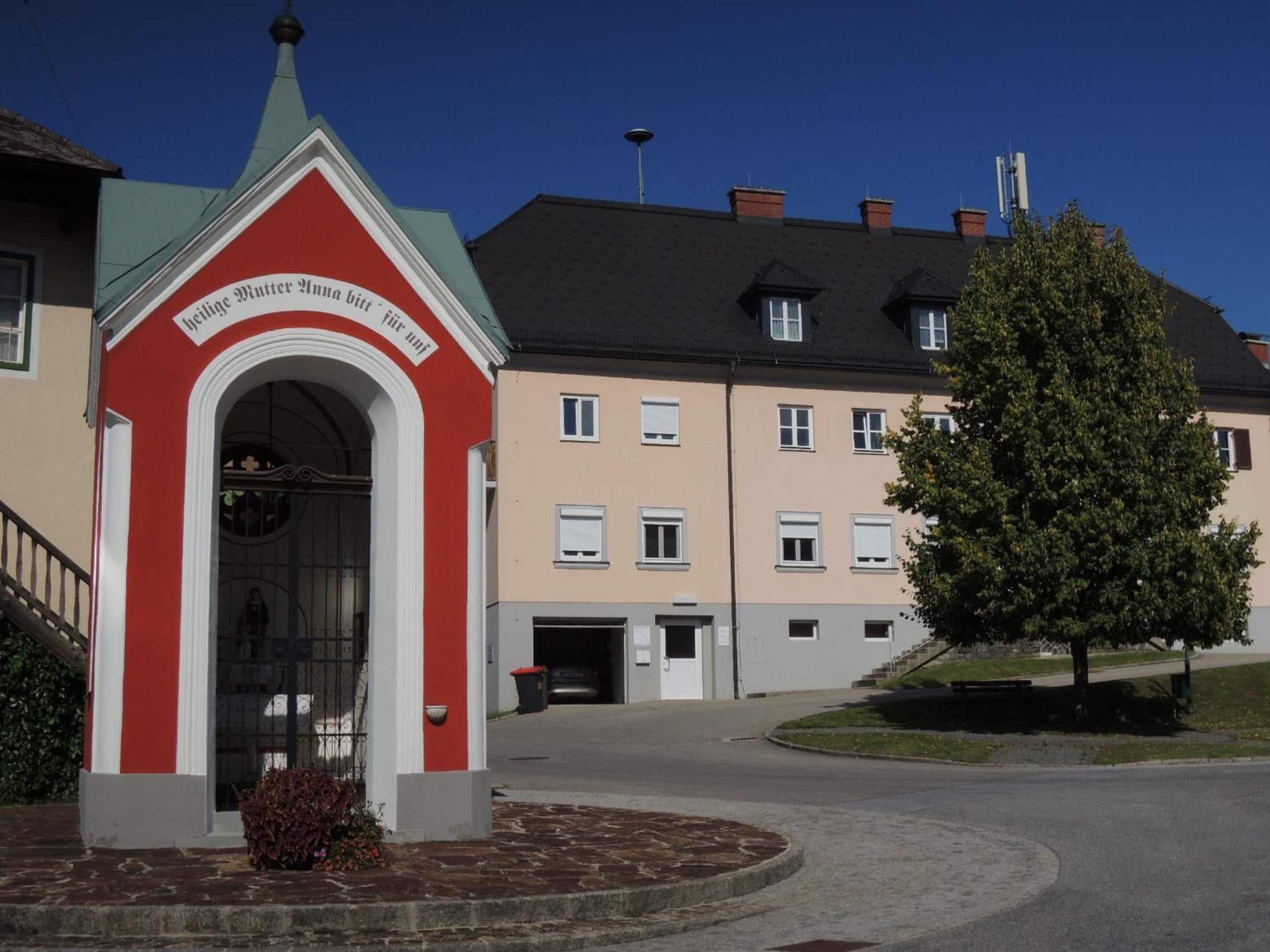 A building with a red entrance archway and a sign above it.