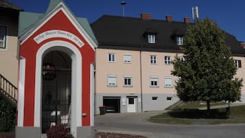 A building with a red entrance archway and a sign above it.