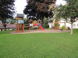 A playground with a slide, climbing structures, and a swing set. - Apartment 'Familienglück in Der Weststeiermark' with Wi-Fi (Sankt Oswald ob Eibiswald)