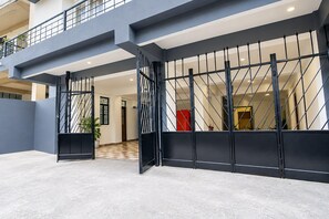 A modern building entrance with a metal gate and a checkered floor.