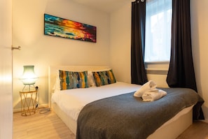 The second bedroom has a double bed with blackout curtains at the window. - Ground-Floor 2-Bed Sleeps 4 · Parking · Walk to Cardiff Bay (Cardiff)