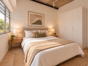 A bedroom with a large bed, bedside lamps, a painting, and a wardrobe. - Executive 2-bed Apartment in Darwin CBD (Darwin)