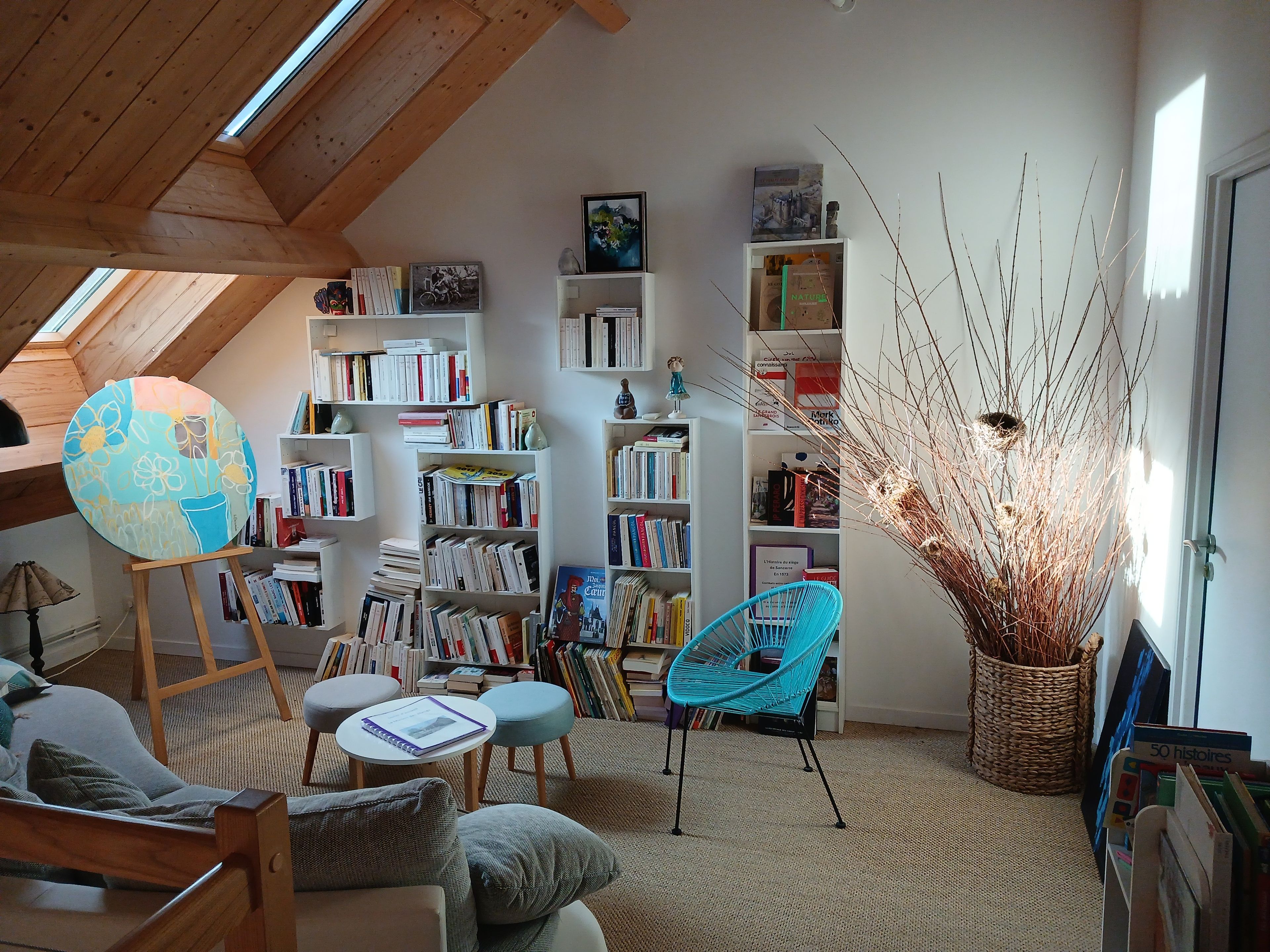 A cozy reading nook with bookshelves, a globe, and a comfortable seating area.