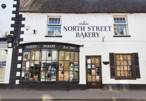 A traditional building with a sign reading 'North Street Bakery' and a date 'Est. 1967' on the facade. - Pam's Cottage: A Cosy Cotswold Home in Winchcombe (Winchcombe)