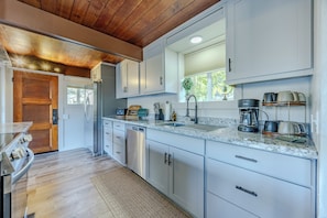 A modern kitchen with stainless steel appliances, white cabinetry, and a wooden ceiling. - New Listing in Eugene's highly sought after "Ferry Street Bridge" neighborhood. (Eugene)