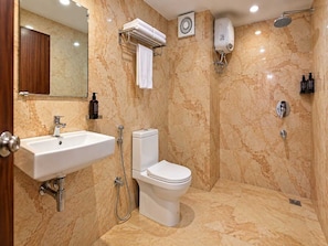 A bathroom with a sink, toilet, and shower. - Classic Hotel Leela Imperial (Visakhapatnam)