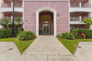 A building entrance with a glass door, a number sign, and a red fire hydrant. - 3BR close to Convention Center and Theme Parks (Orlando)