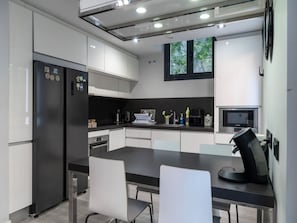 A modern kitchen with a refrigerator, microwave, and coffee machine. - Private Room in Apartment, Madrid (Madrid)