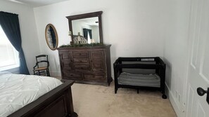 A bedroom with a bed, a dresser, a chair, and a bench. - Charming 4-bedroom house with POOL in peaceful New Columbia (New Columbia)