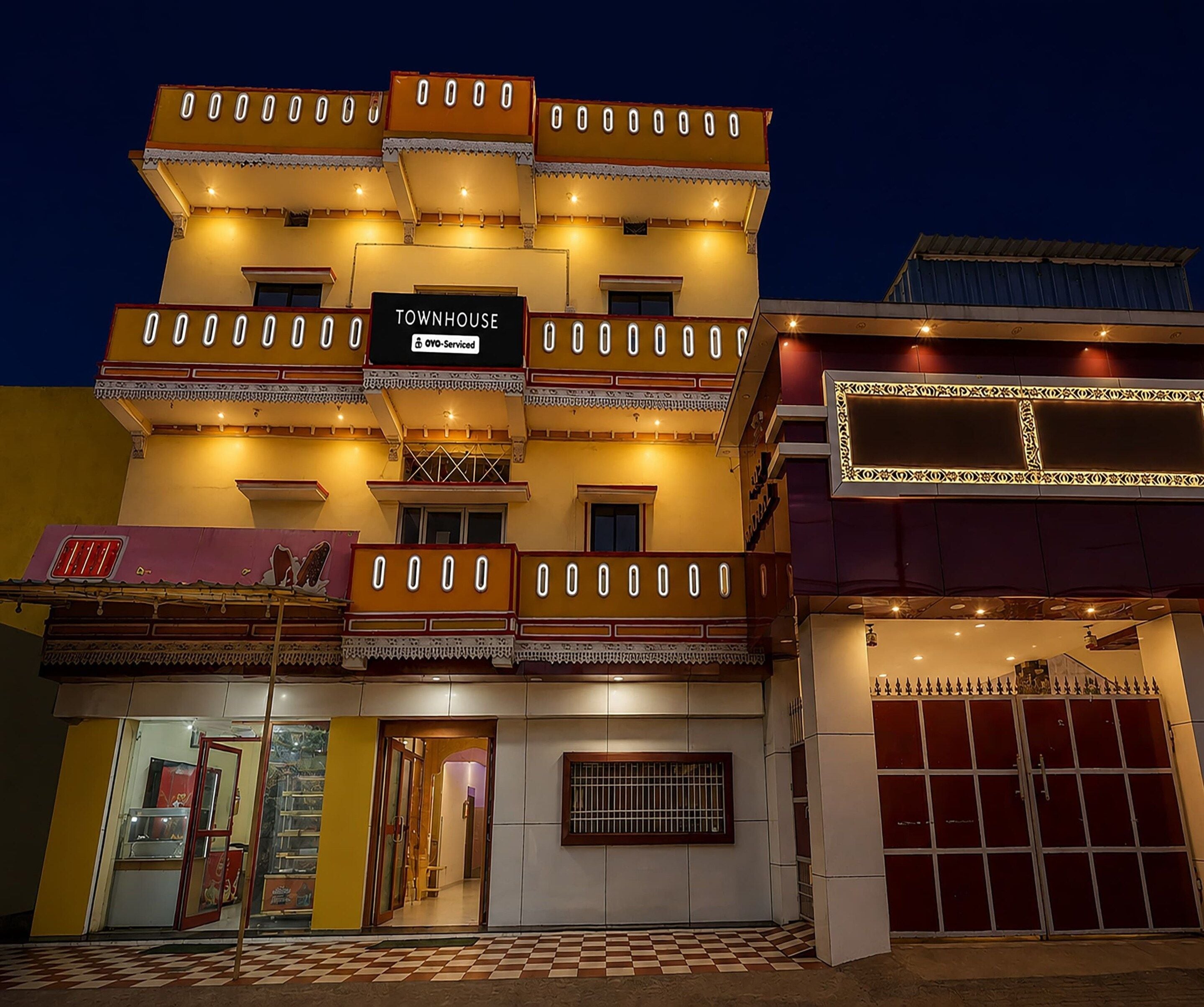 A multi-story building with a sign indicating it is a townhouse.