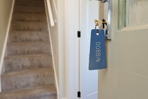A staircase leading to a room with a door handle and a blue tag with the name 'DOBBIN' on it. - Ross-on-Wye Stone Cottage | Fishing | Sleeps 4 (Bridstow)