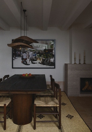 A dining area with a large table, chairs, a hanging light fixture, and a framed picture on the wall. - Neighbours Boutique Riad Marrakech (Marrakech)