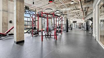 A gym with various exercise equipment, including a pull-up bar and weight machines.