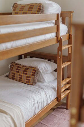 A bunk bed with white bedding and a patterned pillow. - Luxury Designer Collection 519 - Fulton Market (Chicago)