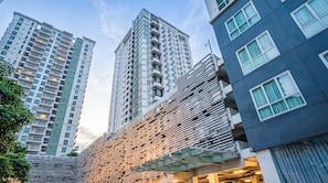 A modern high-rise building with multiple balconies and a unique facade.