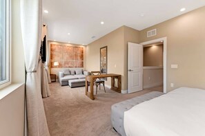 A bedroom with a bed, a sofa, a table, and a wardrobe. - Luxury 3BR Villa w/ BBQ Near Disney (Kissimmee)