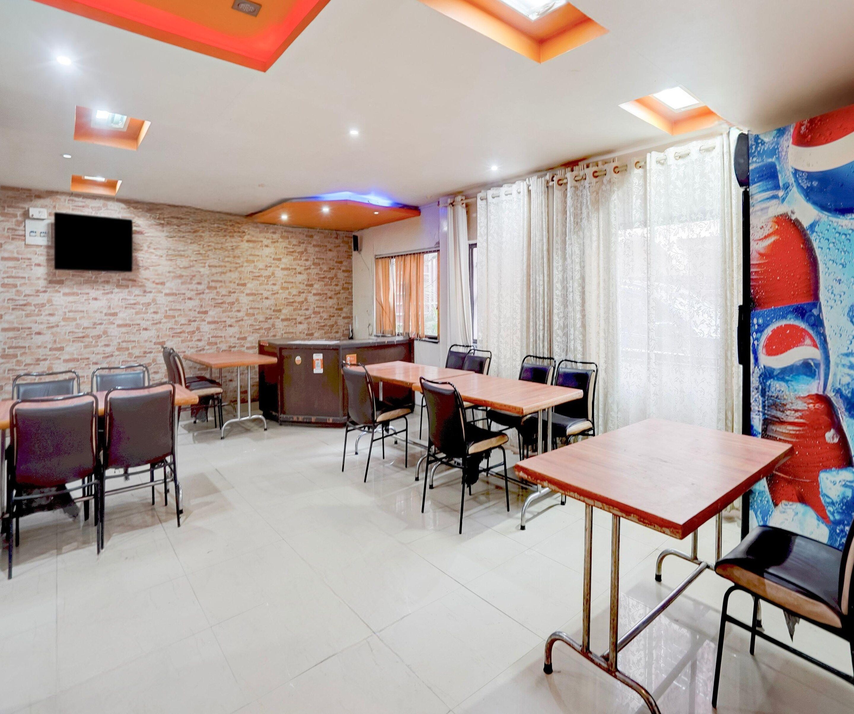 A conference room with a brick wall, a reception desk, and a large window with curtains.
