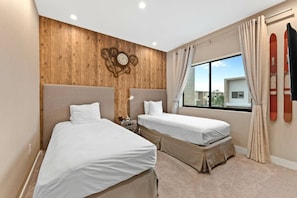 A hotel room with two beds, wooden paneling on the wall, a clock, and a window with curtains. - Magic Village 3BR w/ Jacuzzi & BBQ Near Disney (Kissimmee)