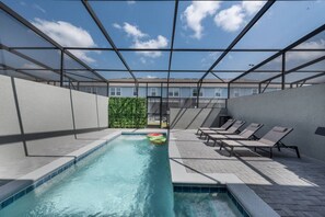A swimming pool with lounge chairs and a glass ceiling. - Luxury 5BR Villa w/ Pool & Themed Rooms (Davenport)
