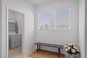 A laundry room with a bench and a potted plant. - Cozy 3BR in Champions Gate With Amazing Views! (Davenport)