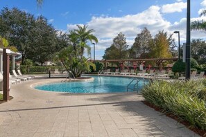 A pool area with lounge chairs and a pergola. - 3BR Lucaya Village Home, Sleeps 8 (Kissimmee)