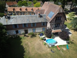 A large house with a swimming pool and a garden.