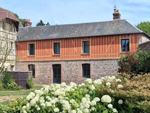 A two-story building with a brick facade and multiple windows.