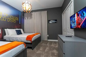 A hotel room with two beds, a TV, a Star Wars poster, and a Star Wars-themed wall decoration. - 5BR Villa w/ Pool & Disney Themes (Kissimmee)
