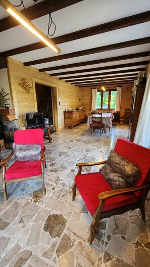 A rustic interior with stone flooring, wooden furniture, and a fireplace. - Quiet 8-person chalet with a magnificent view of the mountains, fireplace,garden (Abondance)