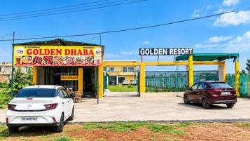 A restaurant named 'Golden Dhaba' with a signboard listing various dishes.