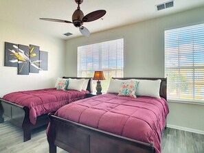 A bedroom with two beds, a ceiling fan, and artwork on the wall. - Vista Cay Resort Orlando 3 Bed 3,5bath Townhouse (Orlando)